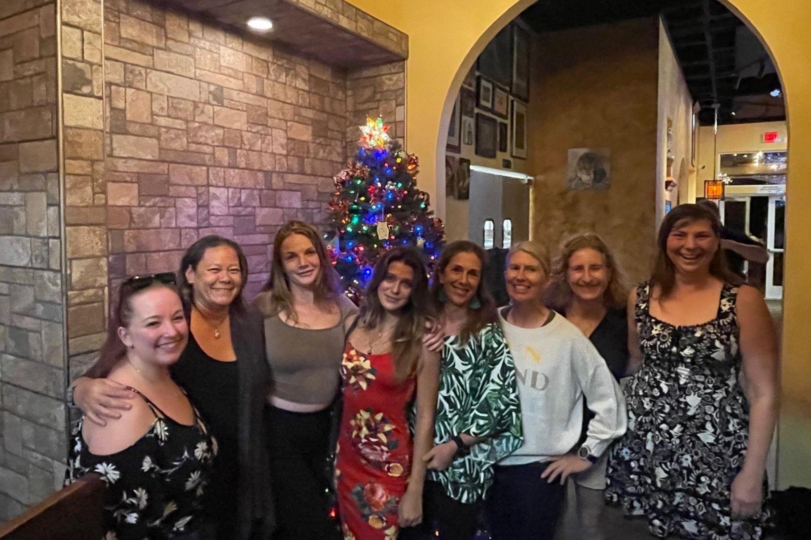 Savannah, Rhiannon, Erin, Hailey, Janine, Kerstin, Martina, and Lisa in front of a Christmas tree. Christmas 2024