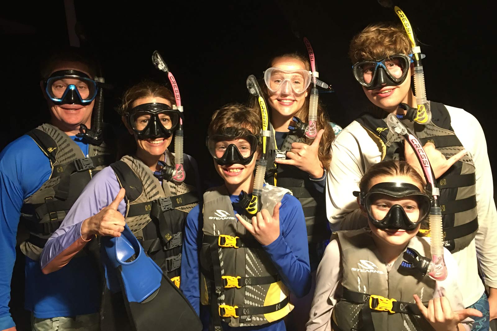 Family with snorkel equipment ready to swim with the manta rays