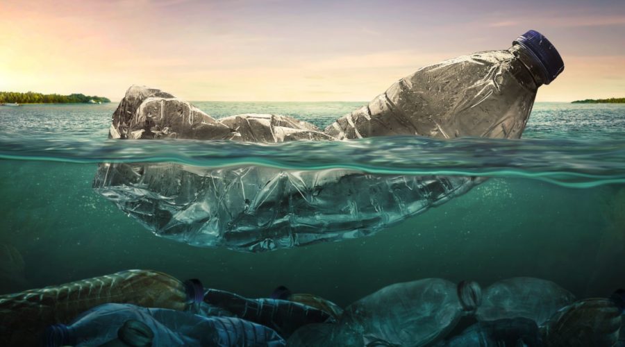 Ocean cleanup organizations: image of plastic bottle floating in the sea