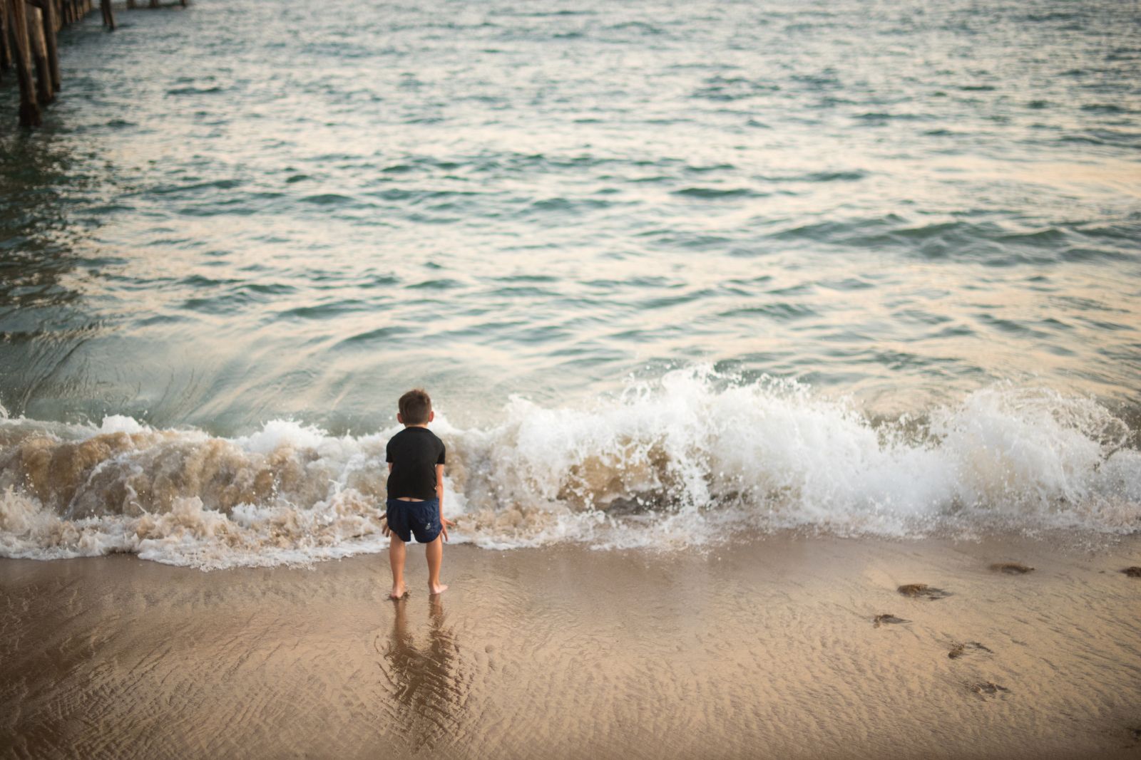 ocean-stories-children Picture of a small child watching the waves, to illustrate the post about ocean books for kids.