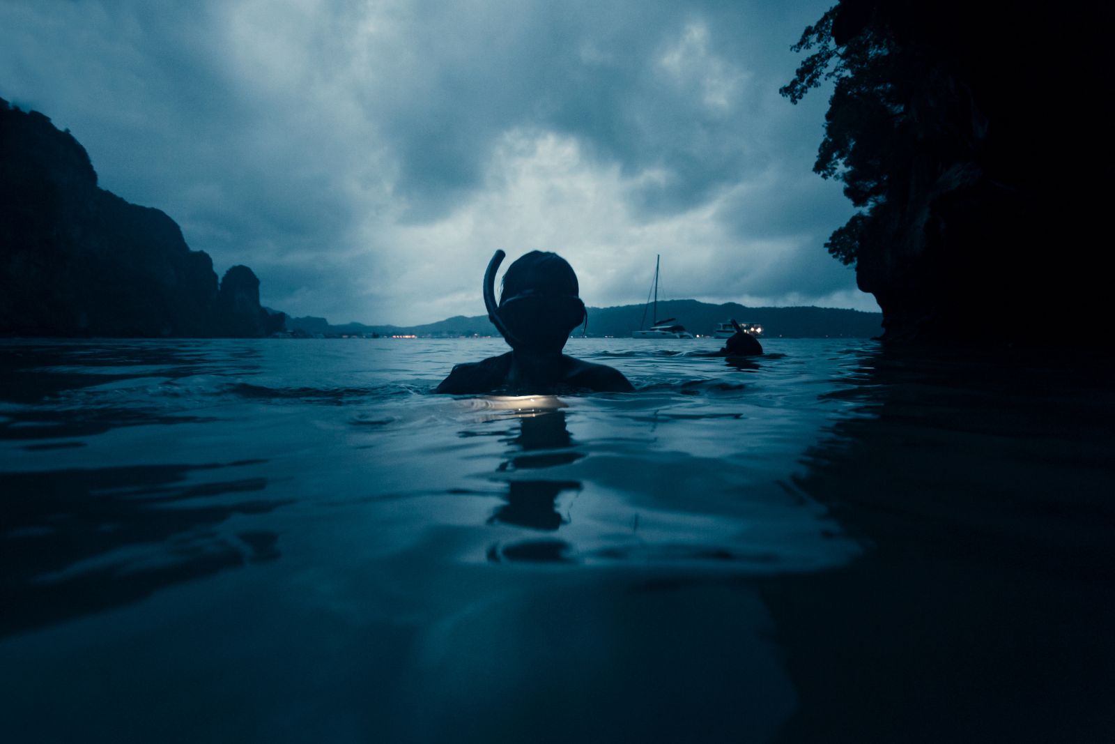 snorkeling gear manta ray swim Person wearing snorkeling gear (snorkel + mask) at night in the ocean