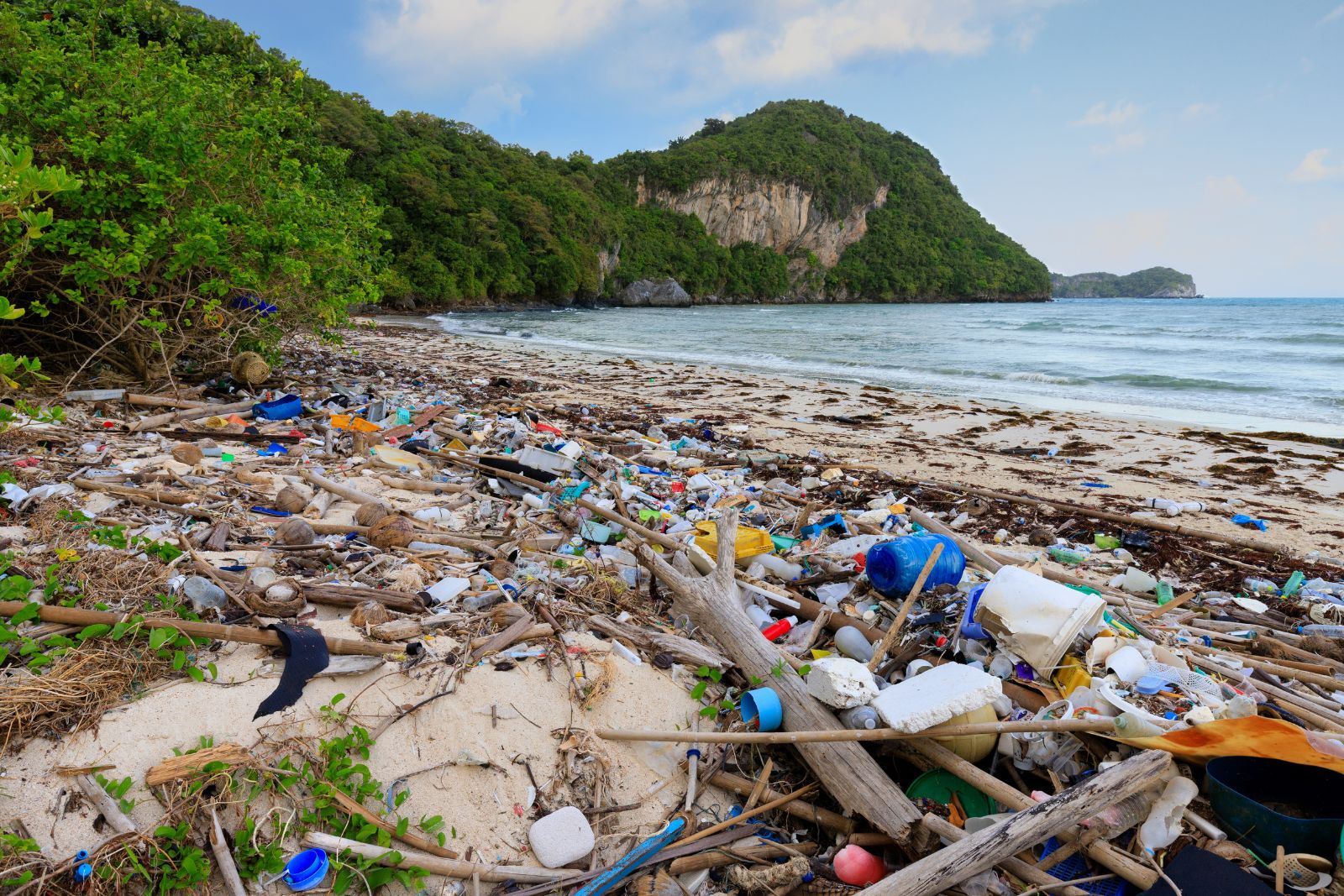 Beach and Coastal Cleanup A beach heavily polluted with plastic waste and other debris, to illustrate a blog post about the importance of coastal cleanup